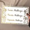 nameplate with floral design in white and gold, rectangle shape with 3 customizable names option