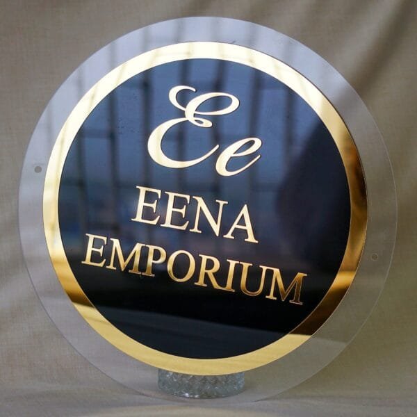 black and golden signage in circular shape with 3d embossed letters and logo