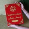 A person's hands holding a large, luxurious red and gold custom Nikah Nama booklet, showcasing its premium quality and size.