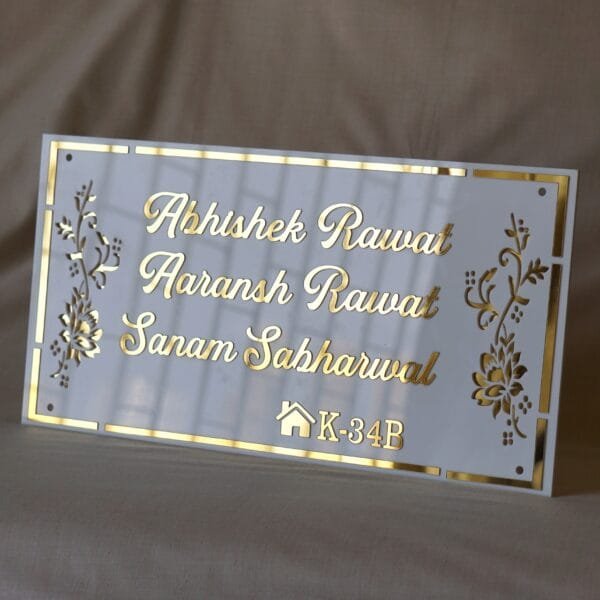 acrylic nameplate with floral design on side and house number in white and gold color in rectangle shape