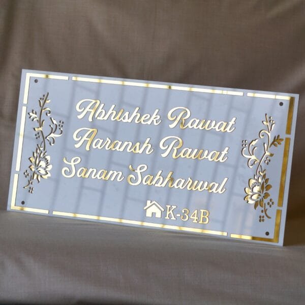 acrylic nameplate with floral design on side and house number in white and gold color in rectangle shape