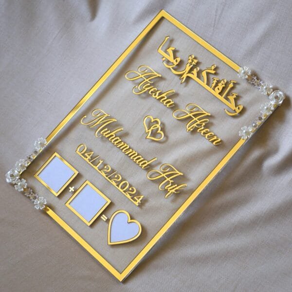 nikah thumb board in transparent and golden color. square design with embellishments on diagonal corners.