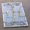 Rectangular white and gold nameplate with floral design, customizable name option.