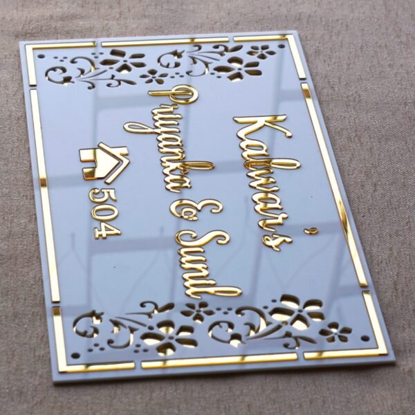 Rectangular white and gold nameplate with floral design, customizable name option.