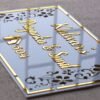 Rectangular white and gold nameplate with floral design, customizable name option.