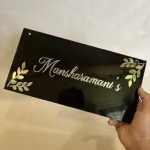 customized acrylic name plate in black and golden color with diagonal leaf design