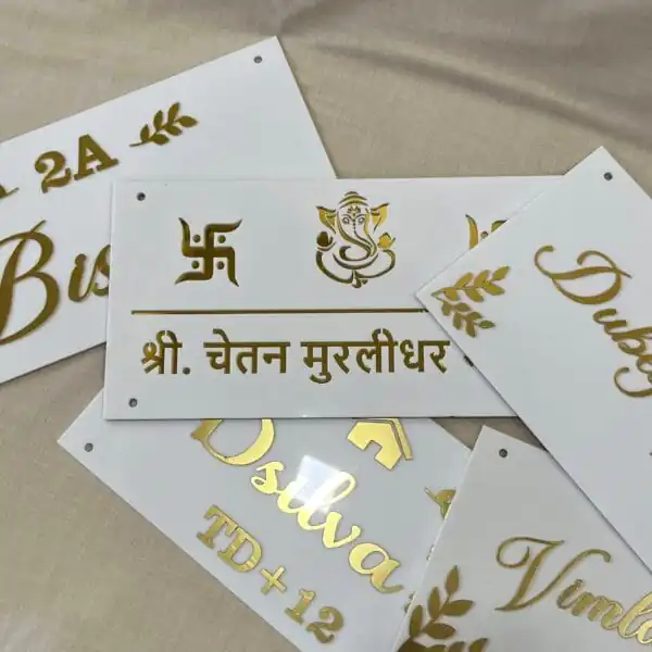 multiple Personalized Acrylic Name Plates in white and gold with leaf design on diagonal corners