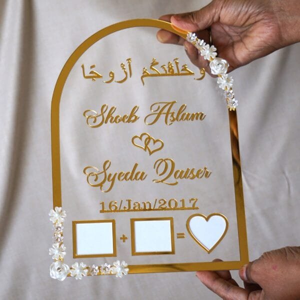 in hand photo of nikah thumb board in golden color with floral embellishments