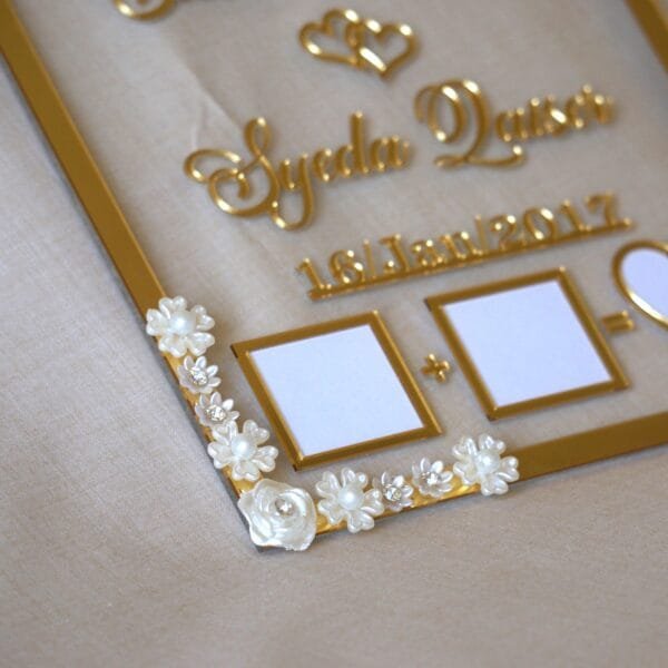 close up photo of nikah thumb board in golden color with floral embellishments