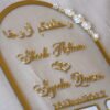 close up photo of nikah thumb board in golden color with floral embellishments