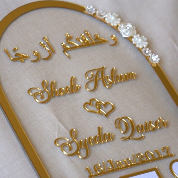 close up photo of nikah thumb board in golden color with floral embellishments