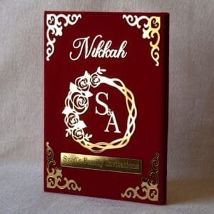 Nikah Invitation Booklet Made using red velvet and golden acrylic, the size of the product is 14 by 12 inches.