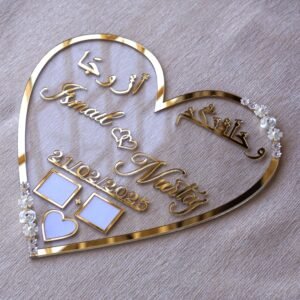 personalized wedding thumb board in heart-shaped design with floral embellishments, this nikah thumb board is made using golden and transparent acrylic sheets. It is used as a wedding keepsake that can be showcased on a cabinet.
