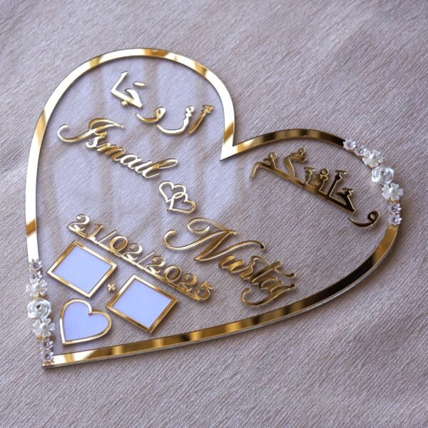 personalized wedding thumb board in heart-shaped design with floral embellishments, this nikah thumb board is made using golden and transparent acrylic sheets. It is used as a wedding keepsake that can be showcased on a cabinet.