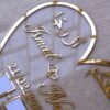 personalized wedding thumb board in heart-shaped design with floral embellishments, this nikah thumb board is made using golden and transparent acrylic sheets. It is used as a wedding keepsake that can be showcased on a cabinet.