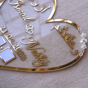 personalized wedding thumb board in heart-shaped design with floral embellishments, this nikah thumb board is made using golden and transparent acrylic sheets. It is used as a wedding keepsake that can be showcased on a cabinet.