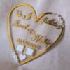 personalized wedding thumb board in heart-shaped design with floral embellishments, this nikah thumb board is made using golden and transparent acrylic sheets. It is used as a wedding keepsake that can be showcased on a cabinet.