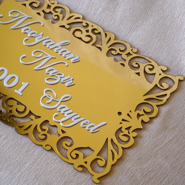 1741871521064 The acrylic nameplate for the home in a Victorian-style border is made using acrylic and MDF for durability, and a golden acrylic sheet is used for royal looks. This nameplate will be a perfect statement piece for the home entrance.