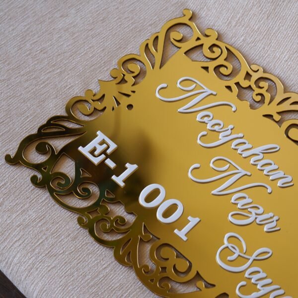1741871521093 The acrylic nameplate for the home in a Victorian-style border is made using acrylic and MDF for durability, and a golden acrylic sheet is used for royal looks. This nameplate will be a perfect statement piece for the home entrance.