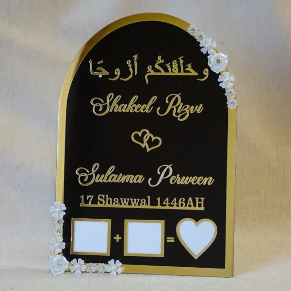 Black and gold acrylic Nikah thumb board with customizable names, ideal for Muslim wedding ceremonies.