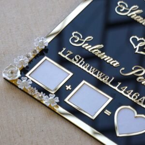 Black and gold acrylic Nikah thumb board with customizable names, ideal for Muslim wedding ceremonies.