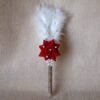“Close-up of a decorative Nikah signing pen featuring a glittery lace-wrapped barrel, a red artificial rose with pearl-studded floral accents, and white feather plumes.”