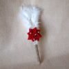 “Close-up of a decorative Nikah signing pen featuring a glittery lace-wrapped barrel, a red artificial rose with pearl-studded floral accents, and white feather plumes.”