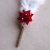 “Close-up of a decorative Nikah signing pen featuring a glittery lace-wrapped barrel, a red artificial rose with pearl-studded floral accents, and white feather plumes.”