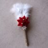 “Close-up of a decorative Nikah signing pen featuring a glittery lace-wrapped barrel, a red artificial rose with pearl-studded floral accents, and white feather plumes.”