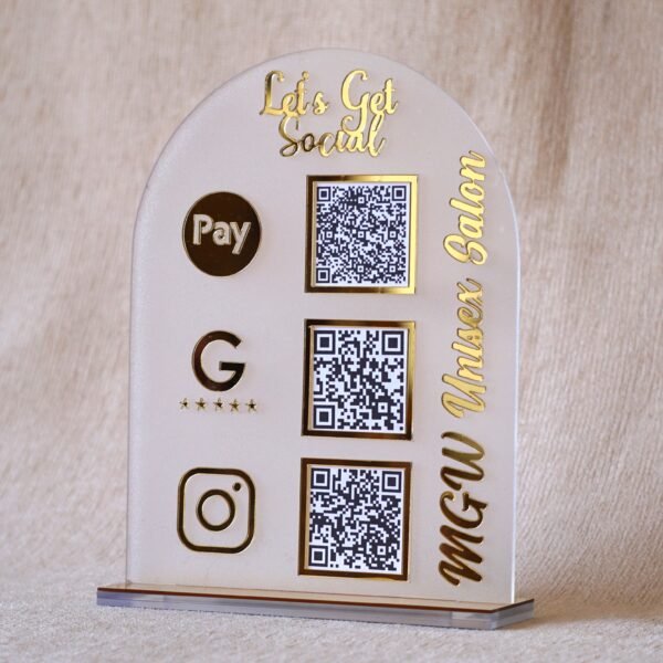 1740235489359 A customizable QR code stand made using imported acrylic and golden sheets is perfect for business desks and exhibitions. The QR codes and brand name can be customized. The stand is removable, and the size of the product is 5 by 7 inches.