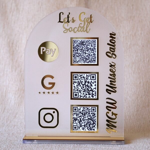 1740235489390 A customizable QR code stand made using imported acrylic and golden sheets is perfect for business desks and exhibitions. The QR codes and brand name can be customized. The stand is removable, and the size of the product is 5 by 7 inches.