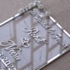 Transparent & silver acrylic personalized wedding thumbprint frame with floral corner embellishments, embossed bride and groom names and date, plus dedicated thumbprint spaces.