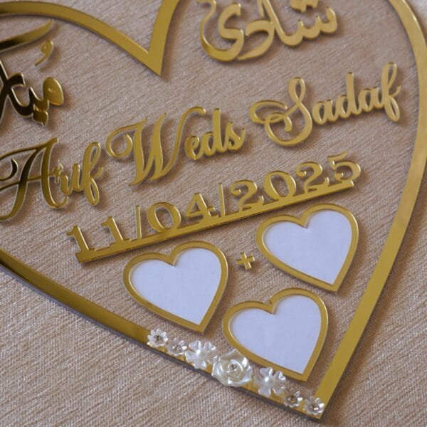 DSC07587 heart shape nikah thumb in golden color with floral embellishments. The size of this nikah thumb board is 12 by 12 inches. This can be used to add a special moment to the wedding, and it can also be kept as a wedding keepsake.