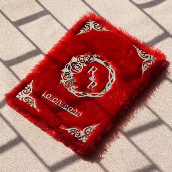 A red fur–clad nikah nama booklet with an acrylic cover and MDF backing, opened to blank pages for the bride’s and groom’s thumbprints and signatures as a lasting wedding keepsake