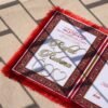 A red fur–clad nikah nama booklet with an acrylic cover and MDF backing, opened to blank pages for the bride’s and groom’s thumbprints and signatures as a lasting wedding keepsake