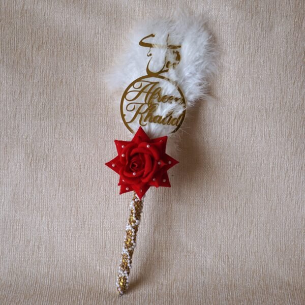 "Customizable Nikah pen adorned with feathers, decorative lace, a rose, and a personalized acrylic name cutout—ideal for signing the Nikah Nama.