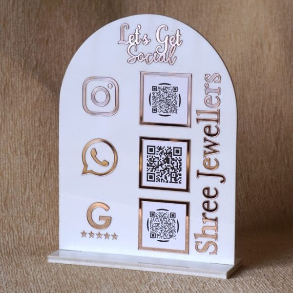 DSC07503 Personalized dome-shaped QR code scanner stand made using rose gold and white acrylic sheet with 3 QR code options and personalized brand name written on the side.