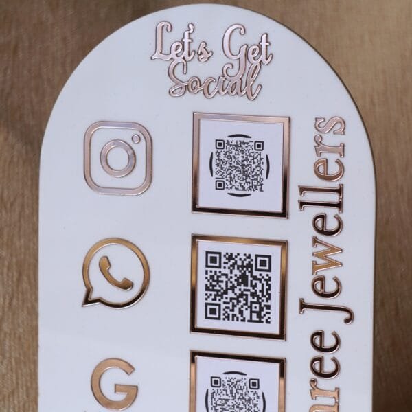 DSC07504 Personalized dome-shaped QR code scanner stand made using rose gold and white acrylic sheet with 3 QR code options and personalized brand name written on the side.