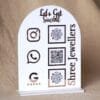 Personalized dome-shaped QR code scanner stand made using rose gold and white acrylic sheet with 3 QR code options and personalized brand name written on the side.