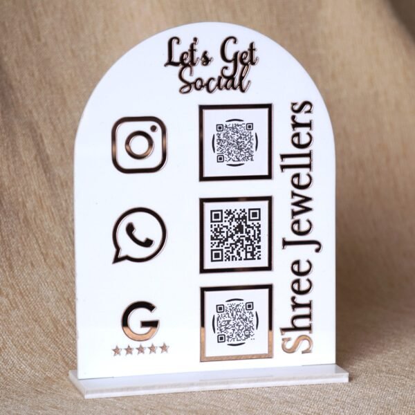 Personalized dome-shaped QR code scanner stand made using rose gold and white acrylic sheet with 3 QR code options and personalized brand name written on the side.