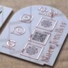Personalized dome-shaped QR code scanner stand made using rose gold and white acrylic sheet with 3 QR code options and personalized brand name written on the side.