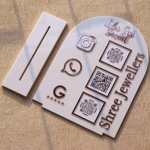 Personalized dome-shaped QR code scanner stand made using rose gold and white acrylic sheet with 3 QR code options and personalized brand name written on the side.
