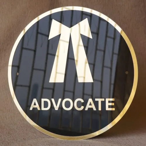 Round 3D embossed advocate signboard, which features a logo. The color combination of this signboard is black and gold, which gives a professional look to the lawyer's office.