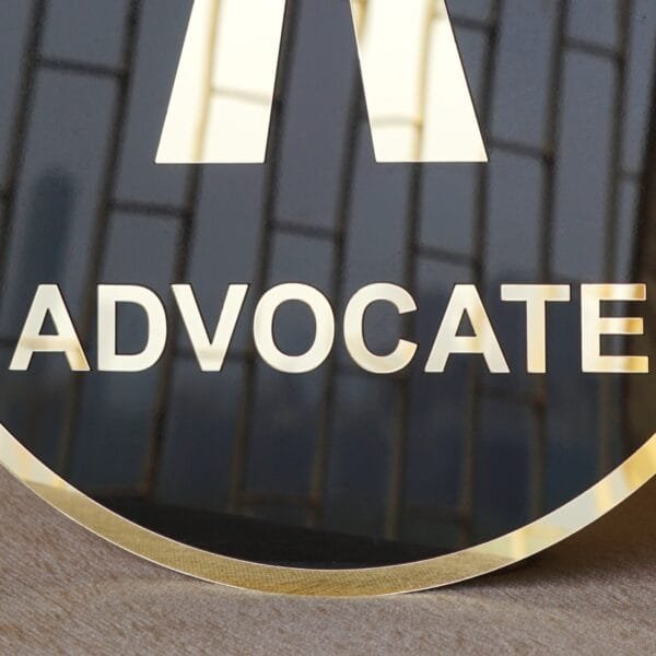 DSC077945 Round 3D embossed advocate signboard, which features a logo. The color combination of this signboard is black and gold, which gives a professional look to the lawyer's office.