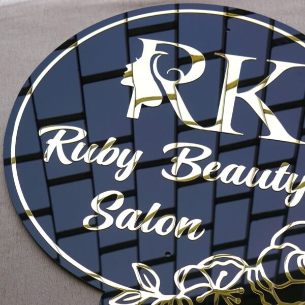Close-up of the 3D gold acrylic lettering on a custom salon sign, highlighting its depth and reflective finish.