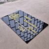 20250616_125118 A high-angle shot of a personalised Islamic nameplate, showcasing the 3D golden calligraphy and letters reflecting a window on its glossy black acrylic surface.