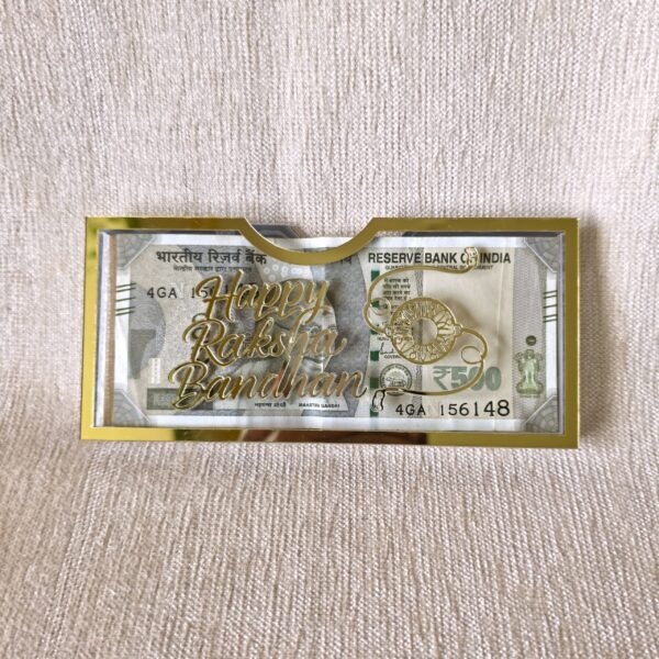 Front view of the 'Happy Raksha Bandhan' acrylic money envelope with gold lettering and a decorative rakhi icon, perfect for gifting cash on the auspicious occasion.