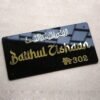 A complete 'Baithul Zishaan' Arabic calligraphy name plate with pre-cut holes for easy wall mounting.