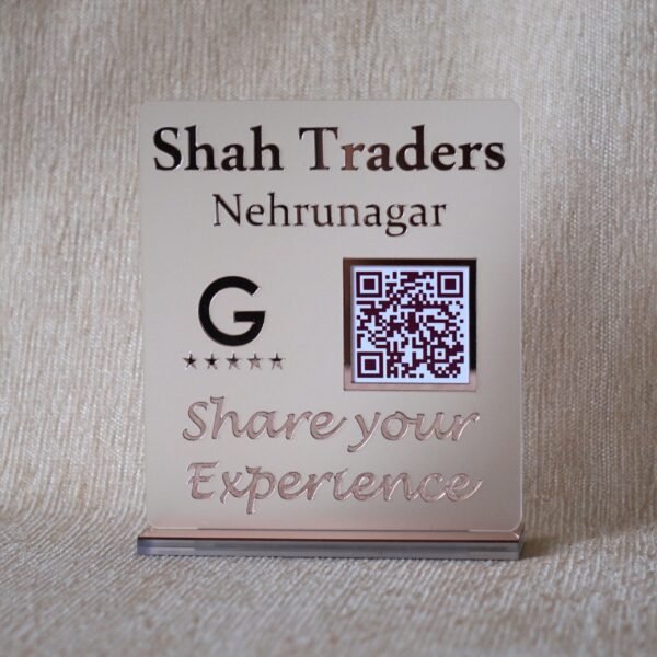 Custom acrylic QR code stand for 'Shah Traders Nehrunagar' in a matte and rose gold finish, designed to increase Google Reviews.