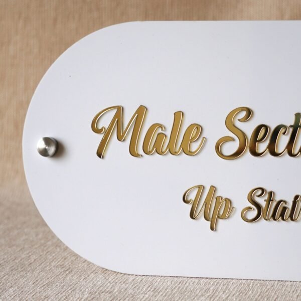 Detailed close-up of the elegant gold script text on the 'Male Section' wayfinding signage for a retail store.